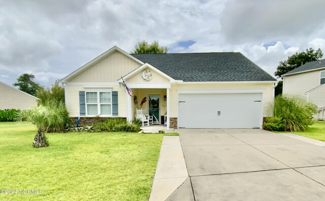 view of front of property featuring a garage and a front yard