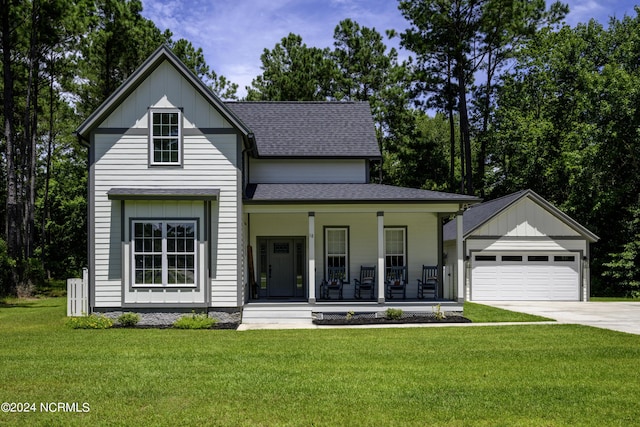 view of front of home featuring covered porch, a front lawn, and a garage