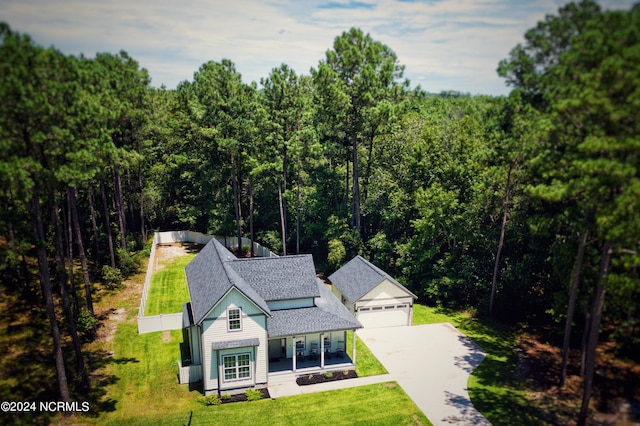 view of front of property with a front yard, a garage, and a porch