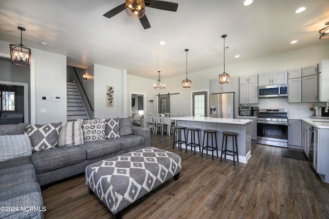 living room with ceiling fan, dark wood-type flooring, and sink