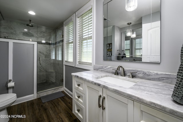 bathroom with hardwood / wood-style floors, an enclosed shower, vanity, and a healthy amount of sunlight