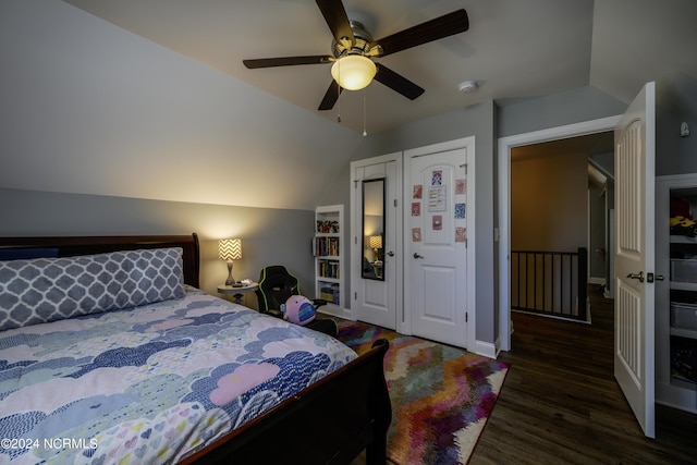 bedroom with ceiling fan, dark hardwood / wood-style floors, and lofted ceiling