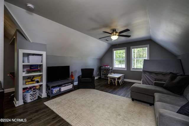 living room with ceiling fan, built in shelves, dark hardwood / wood-style flooring, and vaulted ceiling