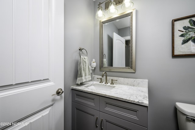 bathroom featuring toilet and vanity