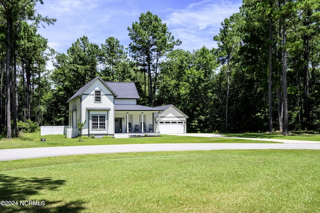 view of front of home featuring covered porch, a front lawn, a garage, and central AC