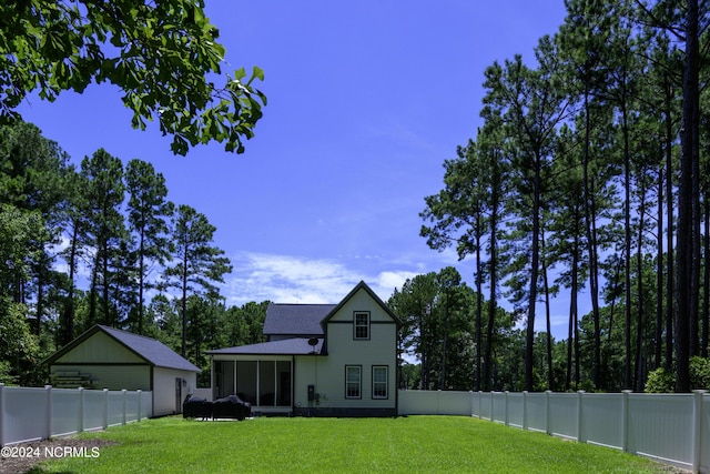 back of property featuring a lawn and a sunroom