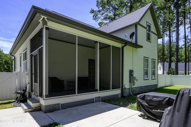 back of house featuring a sunroom and a patio