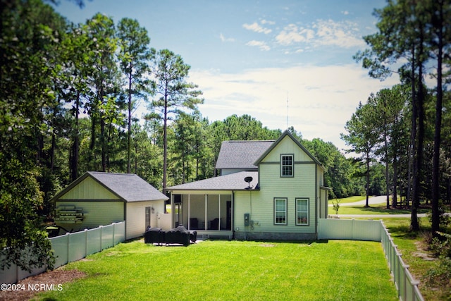 view of front of home featuring a front lawn and a sunroom