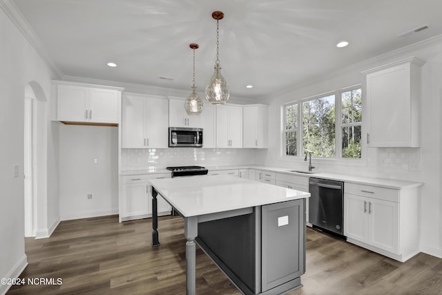 65 Tilloo Cut Way, Hampstead, NC 28443 - kitchen with stainless steel appliances, crown molding, white cabinetry, a center island, and recessed lighting