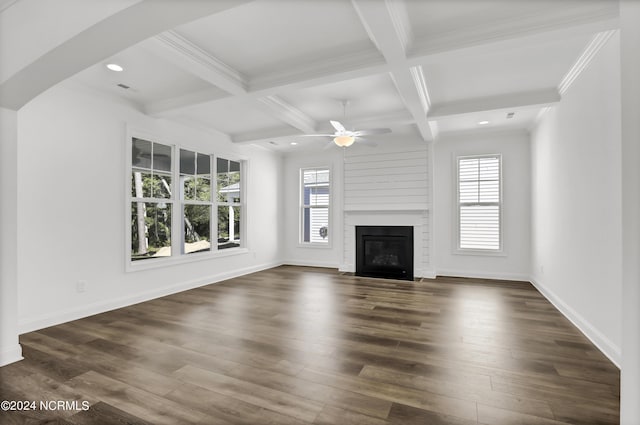 65 Tilloo Cut Way, Hampstead, NC 28443 - unfurnished living room with healthy amount of natural light, beamed ceiling, ceiling fan, arched walkways, and coffered ceiling