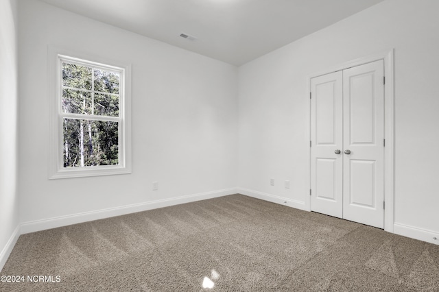 65 Tilloo Cut Way, Hampstead, NC 28443 - unfurnished bedroom featuring carpet flooring, baseboards, and a closet