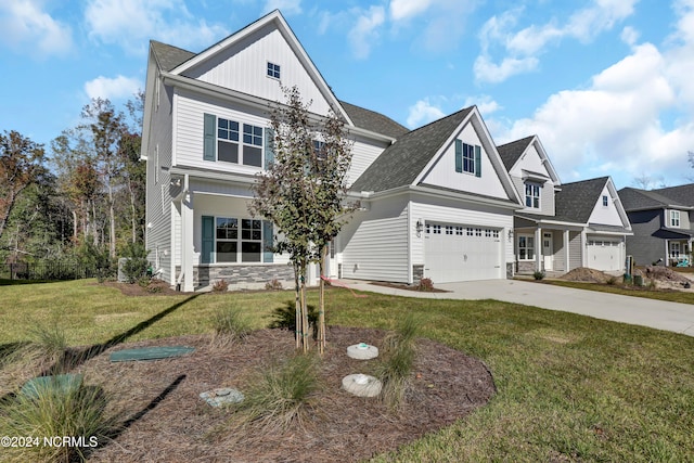 view of front of house featuring a front lawn and a garage