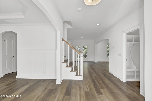 65 Tilloo Cut Way, Hampstead, NC 28443 - entrance foyer with a decorative wall, arched walkways, wood finished floors, stairs, and crown molding