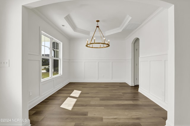 65 Tilloo Cut Way, Hampstead, NC 28443 - unfurnished dining area with arched walkways, a decorative wall, ornamental molding, a chandelier, and wood finished floors