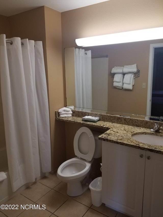 full bath with toilet, vanity, and tile patterned floors