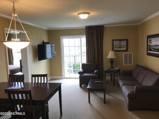 living room featuring ornamental molding, carpet, visible vents, and baseboards