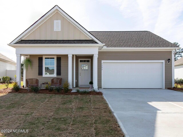 view of front of house featuring a garage and a porch