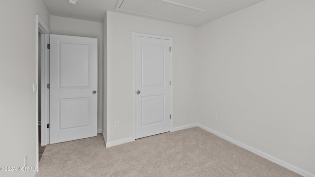 unfurnished bedroom featuring light colored carpet