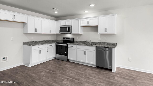 kitchen featuring white cabinets, stone counters, sink, and appliances with stainless steel finishes