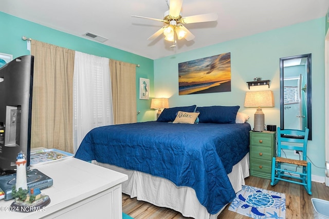 bedroom with light wood-type flooring and ceiling fan