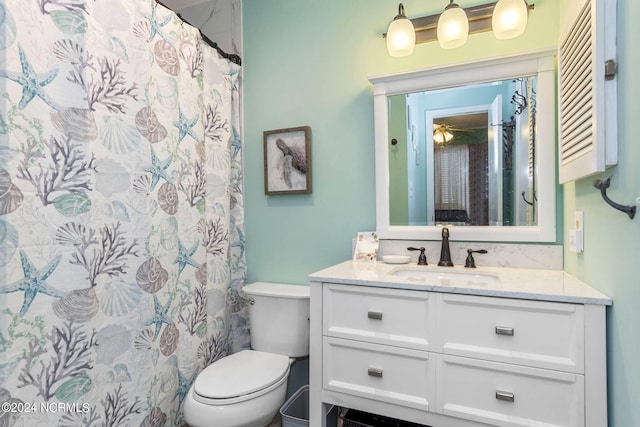 bathroom with toilet, vanity, and ceiling fan