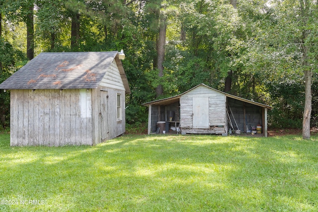 view of outdoor structure featuring a lawn