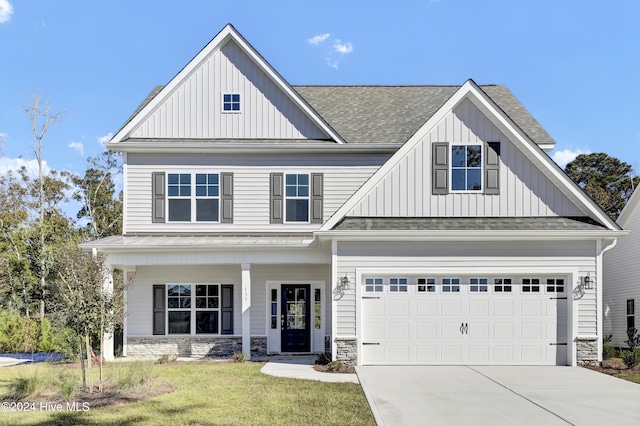 133 Tilloo Cut Way, Hampstead, NC 28443 - view of front of property with roof with shingles, concrete driveway, board and batten siding, and stone siding