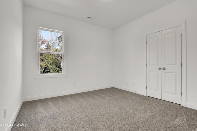 133 Tilloo Cut Way, Hampstead, NC 28443 - unfurnished bedroom featuring carpet floors, baseboards, and a closet