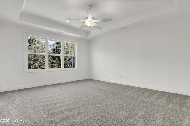 133 Tilloo Cut Way, Hampstead, NC 28443 - empty room featuring a raised ceiling, crown molding, carpet floors, ceiling fan, and baseboards