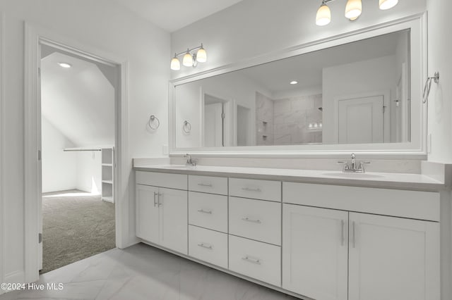 bathroom with vanity and tiled shower