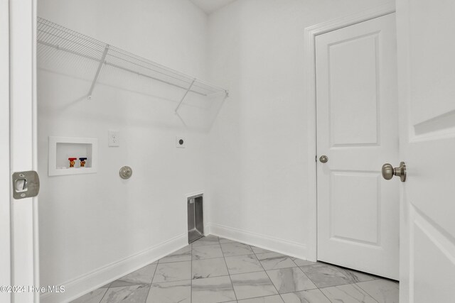 133 Tilloo Cut Way, Hampstead, NC 28443 - washroom featuring light marble finish flooring, hookup for a washing machine, hookup for an electric dryer, baseboards, and hookup for a gas dryer