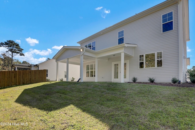 rear view of property featuring a yard