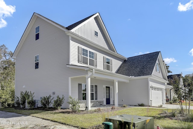 133 Tilloo Cut Way, Hampstead, NC 28443 - view of front of property featuring covered porch, board and batten siding, a garage, and a shingled roof