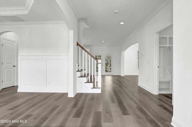 133 Tilloo Cut Way, Hampstead, NC 28443 - hall with arched walkways, stairway, wood finished floors, ornamental molding, and wainscoting