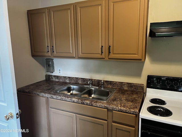 kitchen featuring electric range oven, ventilation hood, dark countertops, and a sink