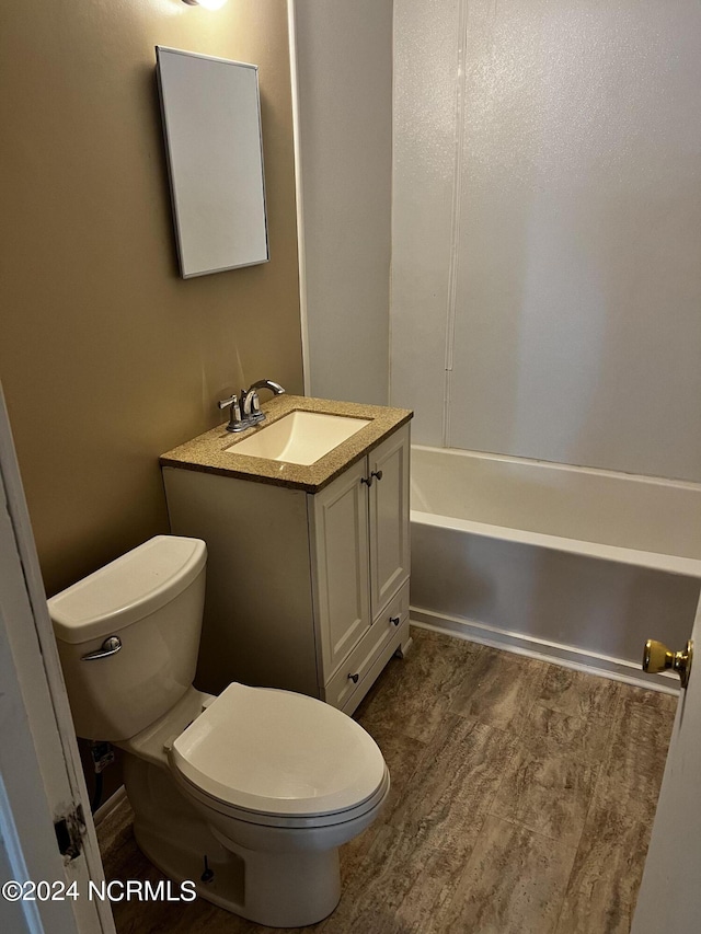 bathroom featuring toilet and vanity