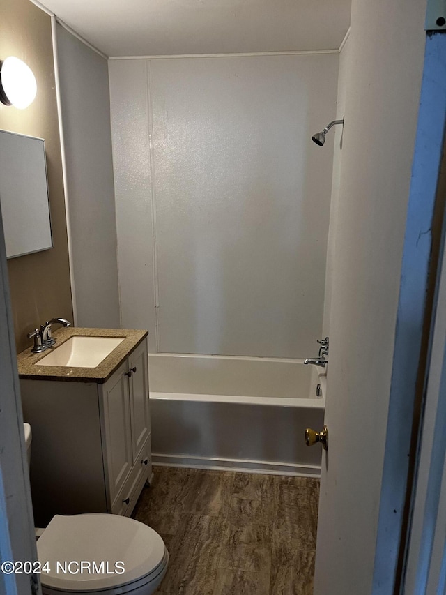 bathroom featuring toilet,  shower combination, and vanity