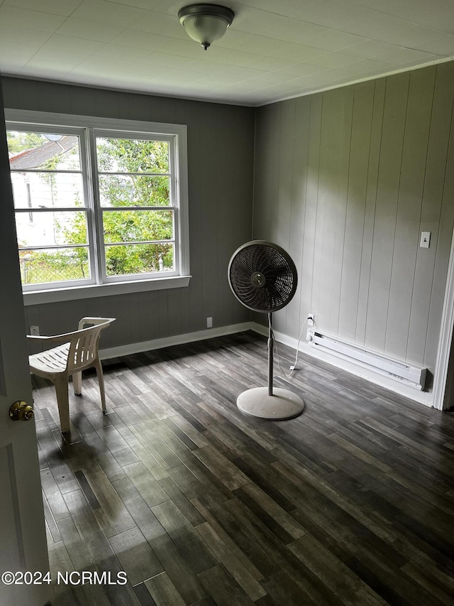 misc room with baseboards, baseboard heating, and dark wood-style flooring