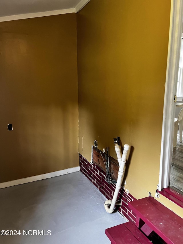 interior details featuring finished concrete floors and baseboards