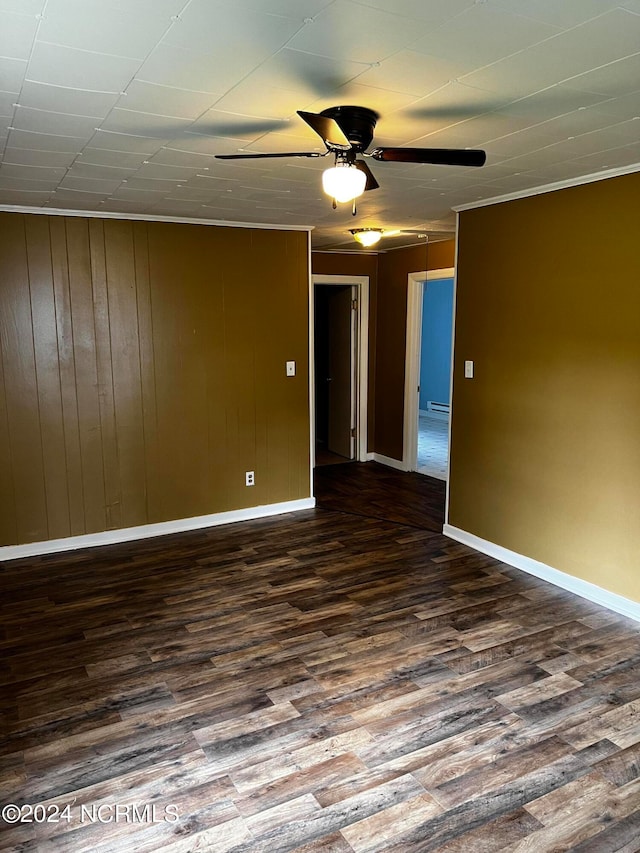 unfurnished room with ceiling fan, baseboards, and dark wood-style flooring