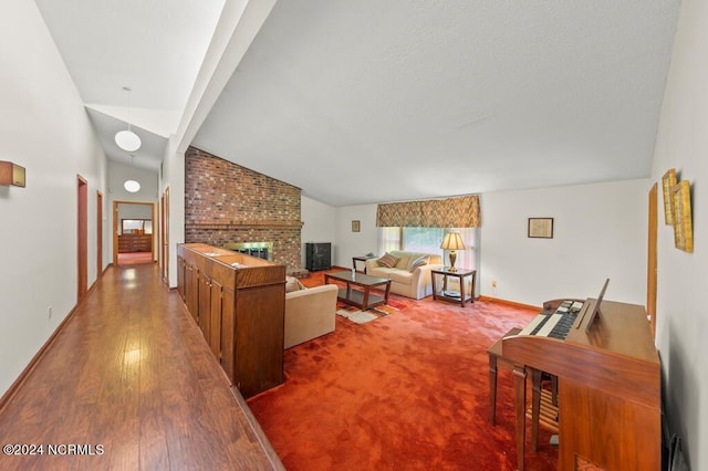 living area featuring a fireplace, baseboards, vaulted ceiling, and wood finished floors