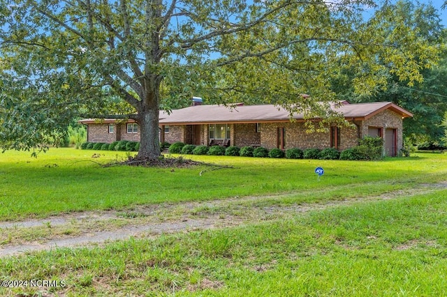 ranch-style home featuring a garage, a front lawn, and brick siding