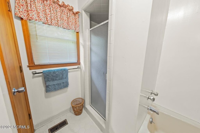 full bath featuring a shower with door, a bathtub, visible vents, and tile patterned floors