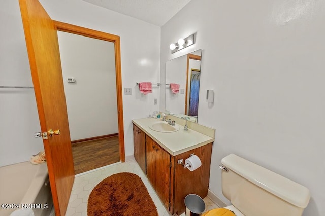 full bath with toilet and vanity