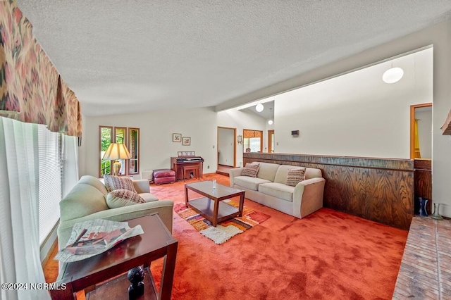 carpeted living area with lofted ceiling and a textured ceiling