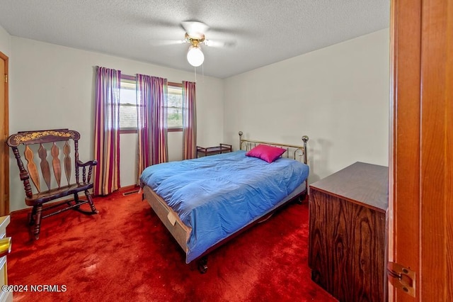 carpeted bedroom with a ceiling fan and a textured ceiling