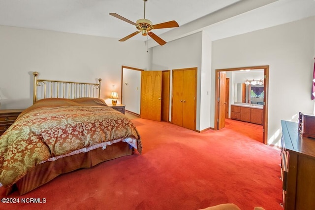 bedroom featuring a closet, a ceiling fan, carpet flooring, vaulted ceiling, and ensuite bath