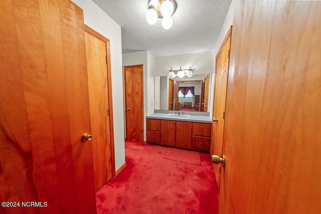 bathroom featuring a textured ceiling and vanity