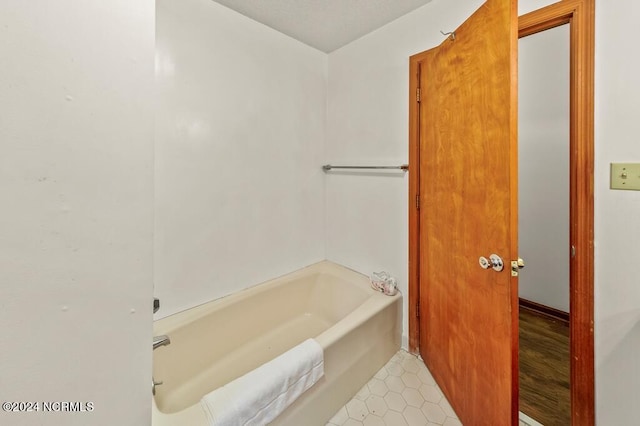 full bathroom with a bathtub and tile patterned floors