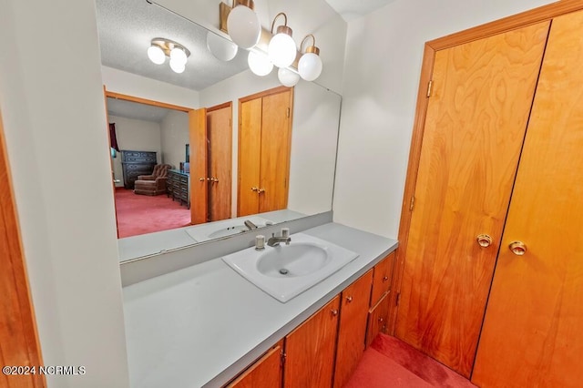 bathroom with a textured ceiling and vanity